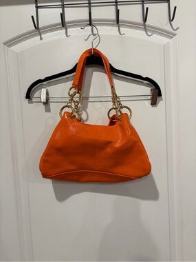 HOBO Bright Orange Leather Shoulder Bag with Gold Rings. View pics of wear